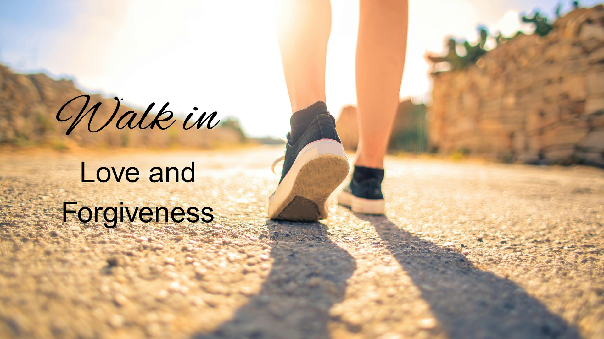Close up of the shoes of someone walking through the desert accompanied with text reading "Walk in love and forgiveness"